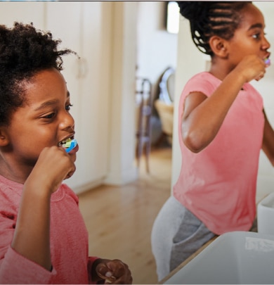 girls brushing their teeth