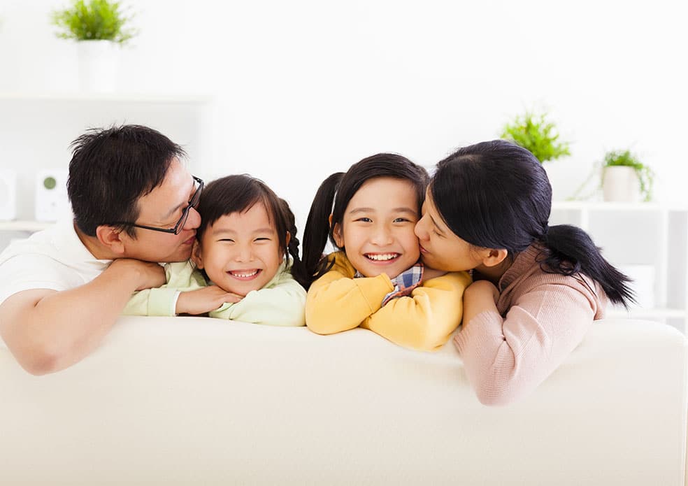 Happy asian family in the living room Shutterstock (Image ID:233044270)