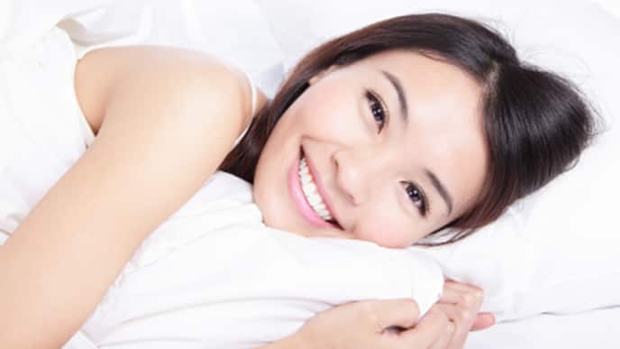 portrait of happiness woman smile lying on bed